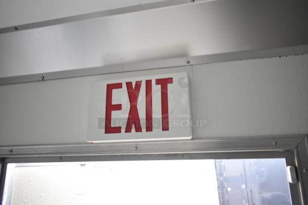 Interior view of 2021 Nationwide 8.5' x 24' food trailer shell showing exit sign above door.