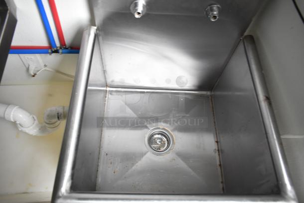 Stainless steel sink in a 2021 Nationwide 8.5' x 24' food trailer shell, featuring plumbing fittings.