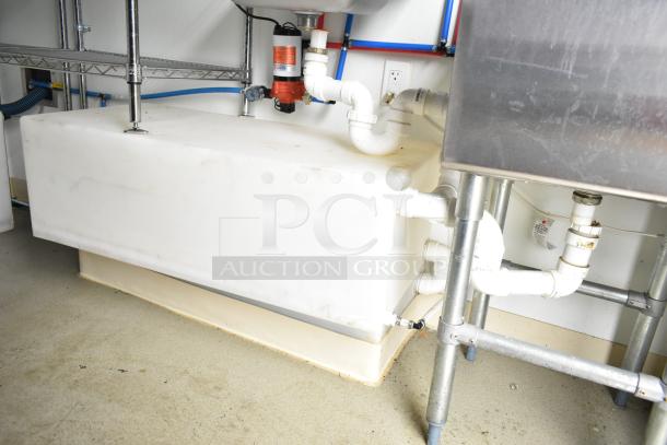 2021 Nationwide 8.5' x 24' food trailer shell interior, featuring plumbing setup, wire shelving, and partial sink installation.