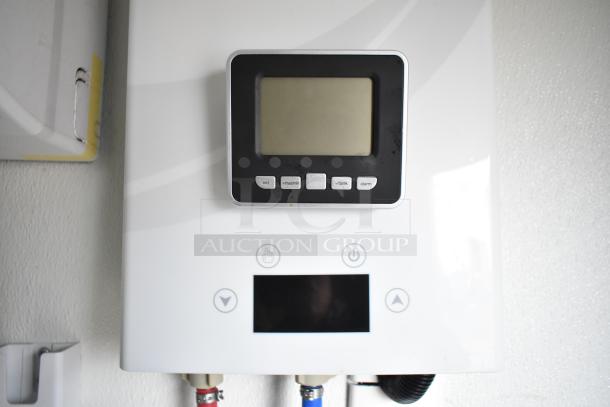 Digital control panel with buttons labeled set, max/min, tank, and alarm on a white appliance.