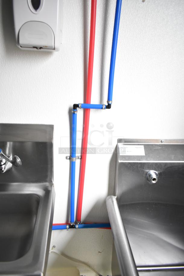 Interior of 2021 Nationwide 8.5' x 24' food trailer with stainless sinks, visible plumbing, and a wire shelving unit.