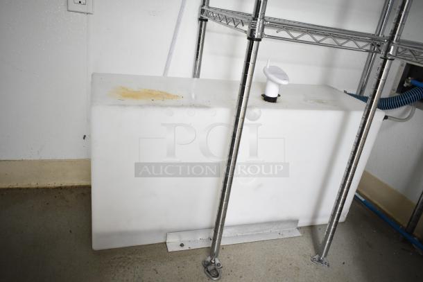 2021 Nationwide 8.5' x 24' food trailer interior with wire shelving, ready for customization. Visible water tank and plumbing.