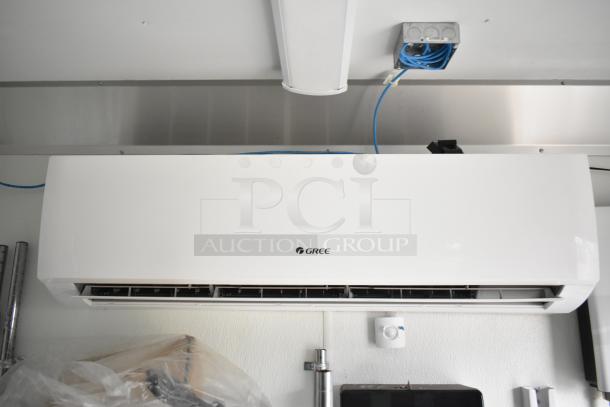 Interior of 2021 Nationwide 8.5' x 24' food trailer shell showing Gree air conditioning unit and wiring, ready for customization.