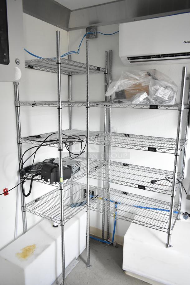 2021 Nationwide 8.5' x 24' food trailer shell with wire shelving units, ready for customization. Includes Martin IT/Network Cabinet.