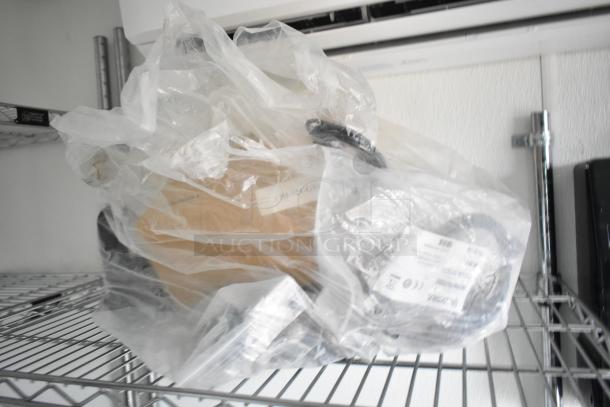Plastic-wrapped item on a wire shelf, packaging shows labels with text and icons, ready for setup in a food trailer.