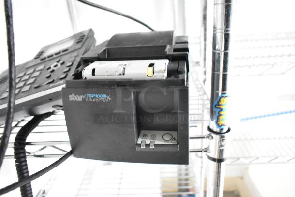 Black Star TSP100III printer on metal wire shelving; includes control buttons and visible wiring next to a phone.