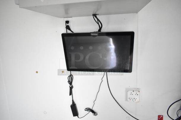 Interior of 2021 Nationwide 8.5' x 24' food trailer shell, showing mounted monitor and outlets, ready for equipment installation.