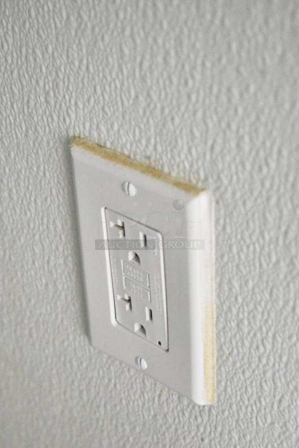 2021 Nationwide 8.5' x 24' food trailer shell interior, featuring an electrical outlet on textured wall, ready for customization.