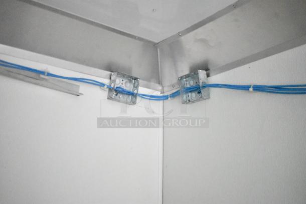 Interior corner of 2021 Nationwide 8.5' x 24' food trailer shell showing blue wiring and metal brackets, ready for customization.