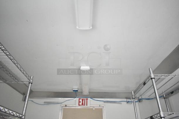 2021 Nationwide 8.5' x 24' food trailer shell interior, features wire shelving units and lighting; ready for customization.