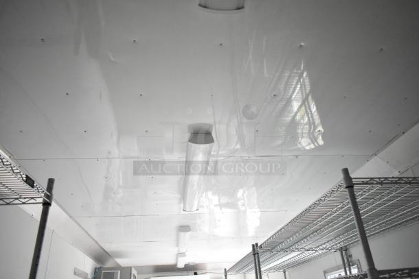 Interior of 2021 Nationwide 8.5' x 24' food trailer shell, featuring wire shelving and fluorescent lighting. Ready for customization.