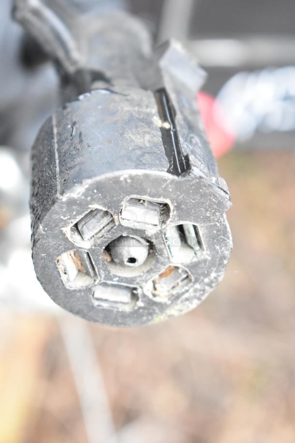 Close-up view of a connector for the 2020 SDG 8.5' x 20' food trailer shell, showing moderate wear.