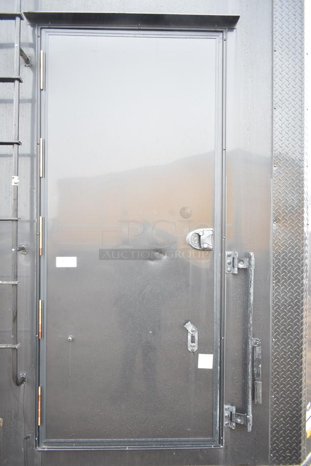 2020 SDG 8.5' x 20' food trailer shell, black exterior, ready to equip. Features include handles and visible lock. Sold with clear title.