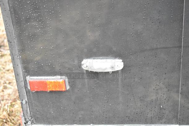 2020 SDG 8.5' x 20' food trailer shell, matte black, raindrops on surface; clear title, ready for customization.