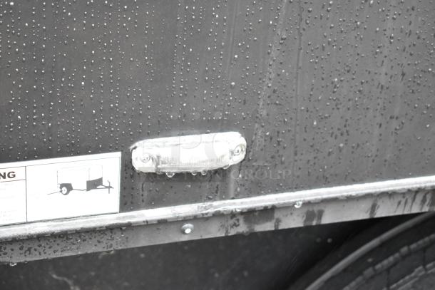 2020 SDG 8.5' x 20' food trailer shell, rain-dappled finish, ready for customization. Label indicates trailer warning instructions.