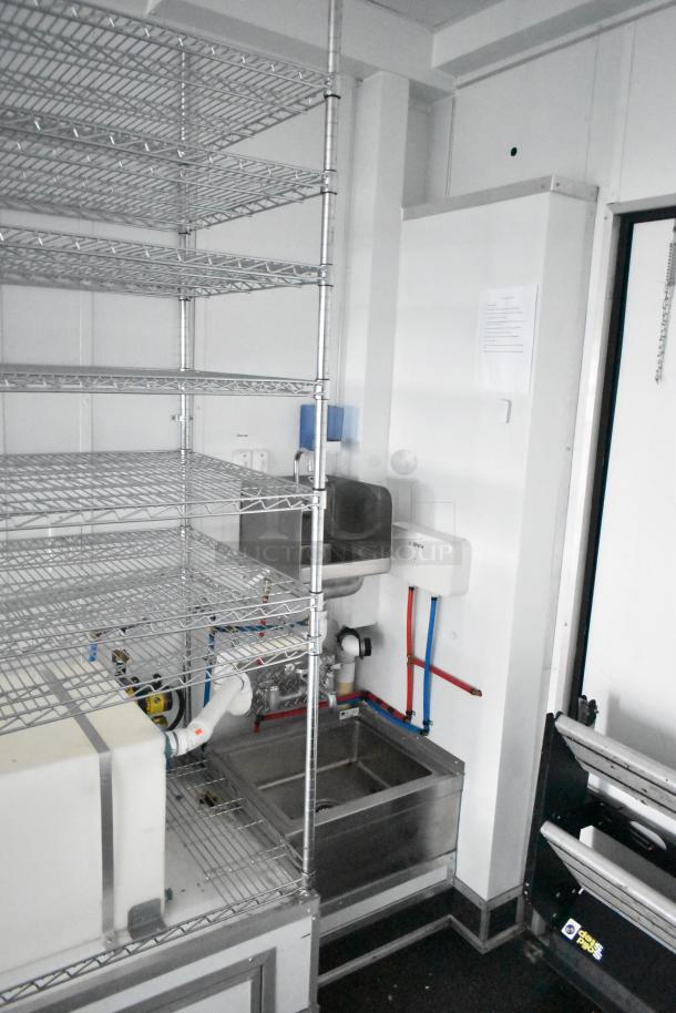 2020 SDG 8.5' x 20' food trailer shell, features sinks, wire shelving units, and Martin IT/Network Cabinet. Clear title.