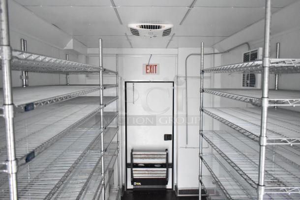 2020 SDG 8.5' x 20' food trailer shell, interior view with wire shelving units and exit door. Ready for custom setup.