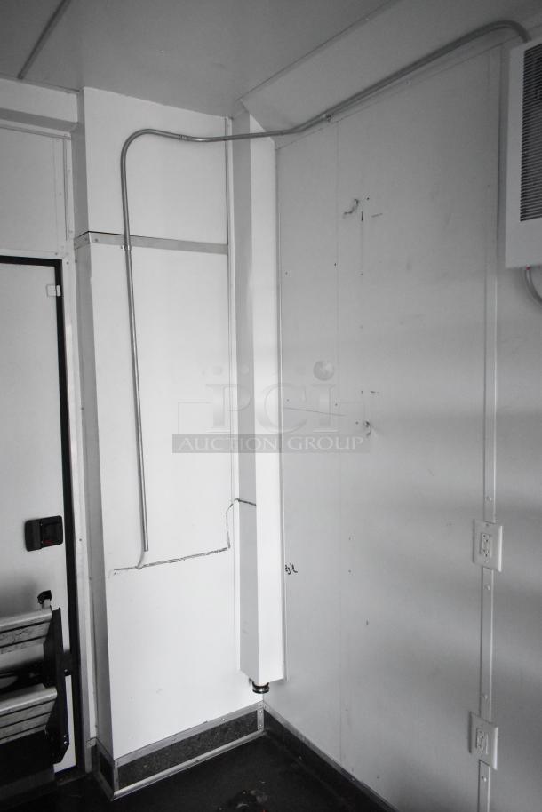 2020 SDG 8.5' x 20' food trailer shell interior, ready for customization. Features wire shelving and Martin IT/Network cabinet.