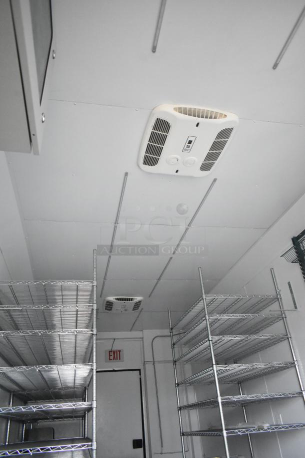 2020 SDG 8.5' x 20' food trailer shell interior with wire shelving units, ceiling vents, and exit sign visible.