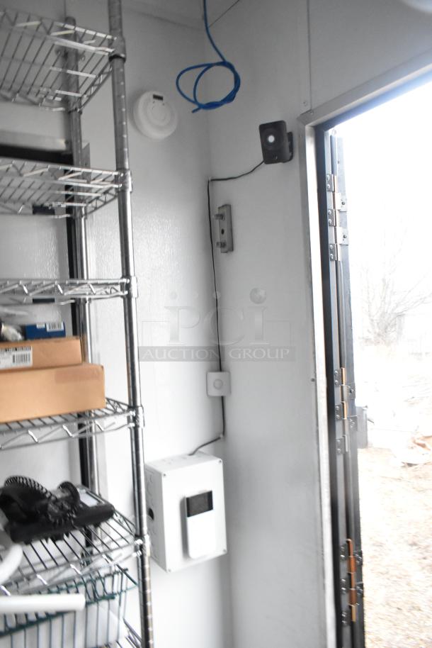 2020 SDG 8.5' x 20' food trailer shell, interior view with wire shelving, IT/network cabinet, and electrical fittings.