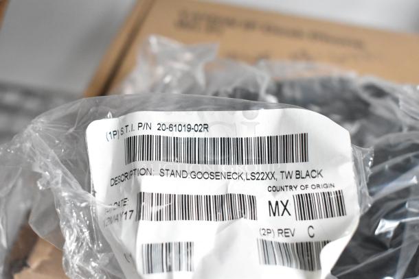A clear plastic tag labeled "STAND, GOOSENECK, LS22XX, TW BLACK," with barcodes and origin marked as Mexico.