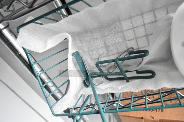 Wire shelving unit inside 2020 SDG Food Trailer Shell. Features sturdy metal construction and ready for equipping.