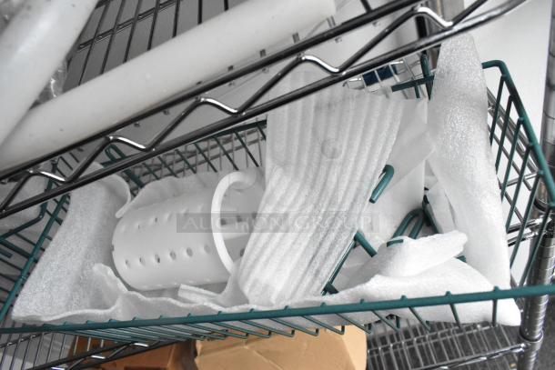 Metal wire shelving with foam packing materials and a white, perforated cylindrical component.