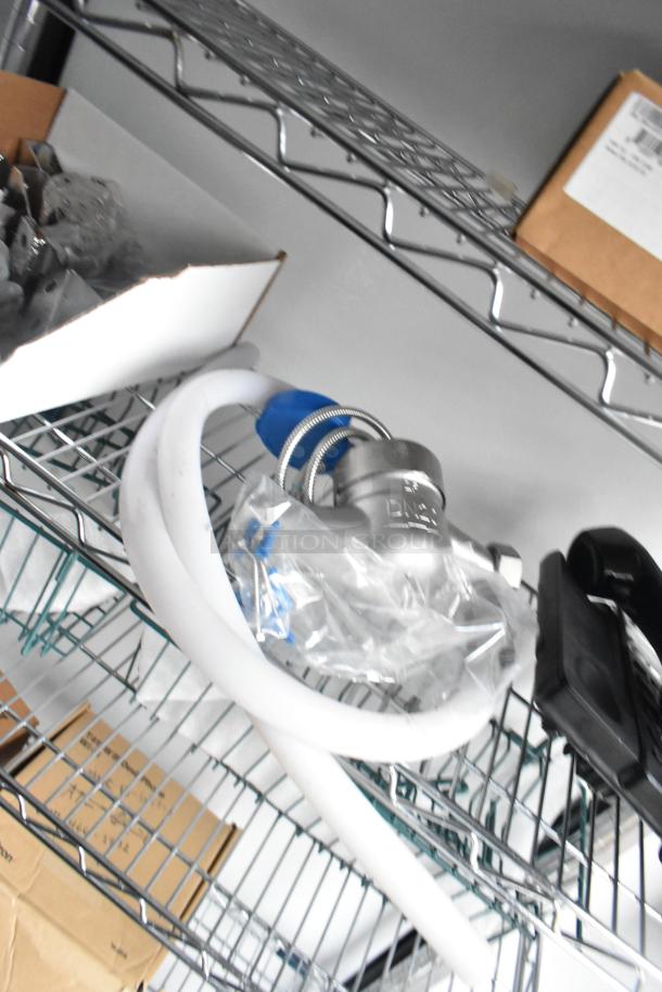 Wire shelving inside a 2020 SDG 8.5' x 20' food trailer shell, featuring hoses and a packaged faucet, ready for equipment installation.