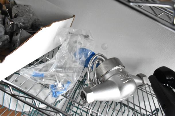 Metal wire shelf with a metallic fitting, sealed screws in a plastic bag, and a cardboard box with various hardware.