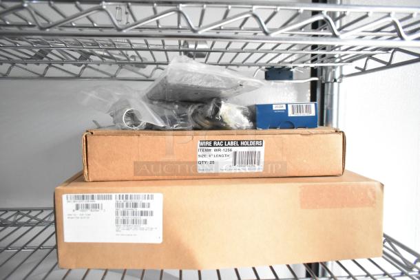 Boxes and items on wire shelving, including Wire Rac Label Holders box labeled 6" length, quantity 25, made in USA.