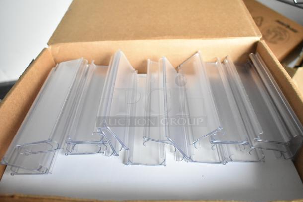Box of clear plastic divider inserts, stacked neatly. Part of food trailer accessories.
