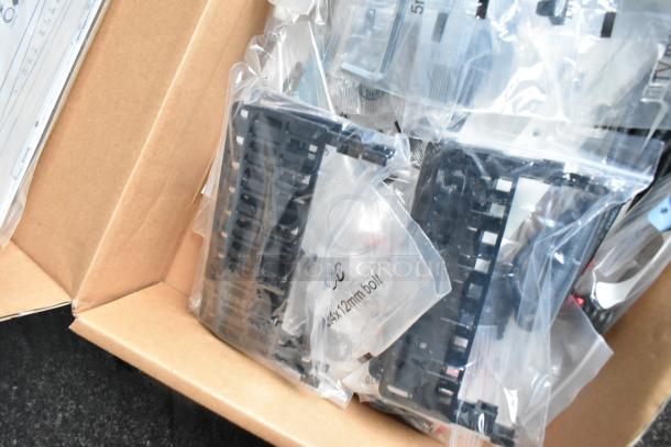 Box of assorted hardware parts, including plastic trays and sealed bags labeled "5x14x12mm bolt."