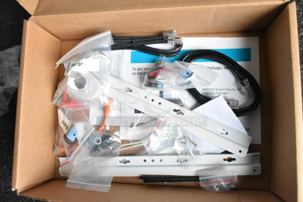 Box of network installation components, including cables, brackets, screws, and labeled parts, ready for setup.