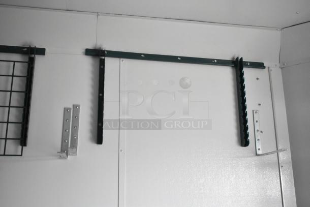 Interior component of a 2020 SDG 8.5' x 20' food trailer shell, featuring metal brackets for wire shelving.