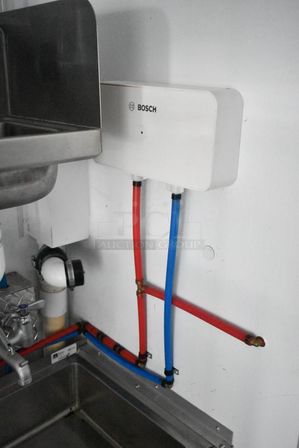 2020 SDG 8.5' x 20' food trailer interior with Bosch water heater, stainless steel sink, and plumbing setup. Ready for customization.