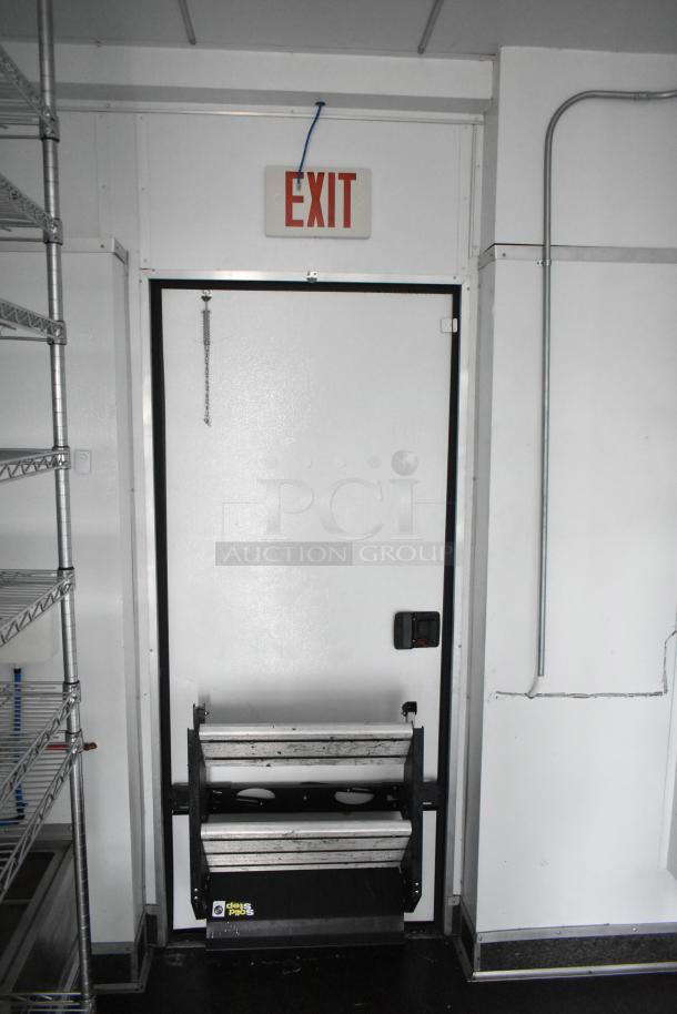2020 SDG 8.5' x 20' food trailer shell with wire shelving, exit sign, and IT/network cabinet; ready for customization.