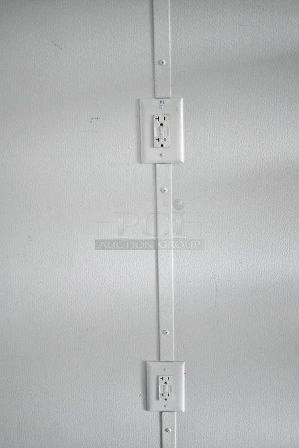 Interior view of 2020 SDG 8.5' x 20' food trailer shell showing electrical outlets on a white wall, labelled "#1".