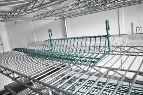 SDG food trailer interior showing wire shelving units, hooks, and outlet. Ready for custom equipment. Clear title, 8.5'x20'.