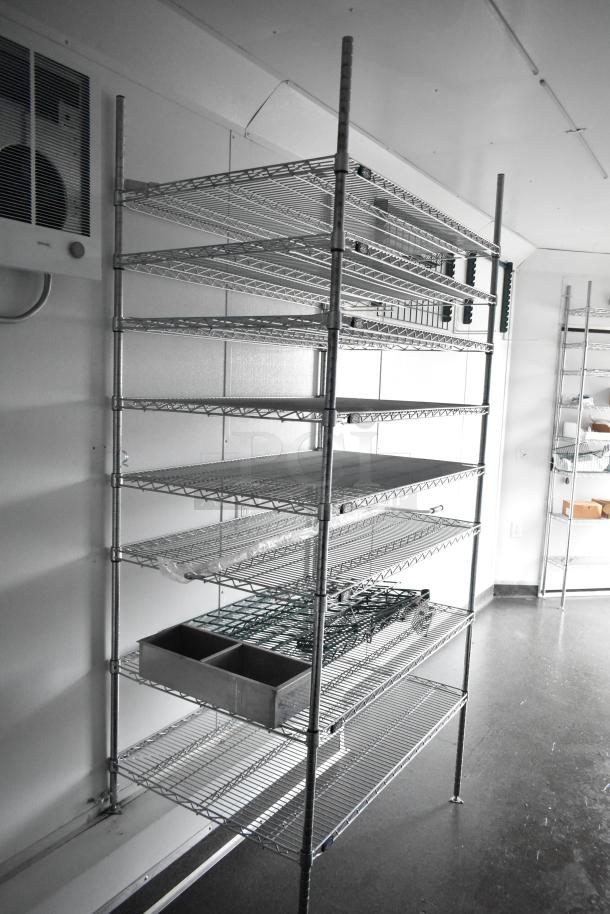 2020 SDG 8.5' x 20' food trailer interior with wire shelving units, ready for customization, includes Martin IT/Network Cabinet.