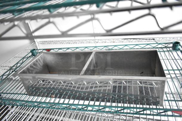 SDG 8.5' x 20' food trailer interior with wire shelving and stainless steel compartment. Ready for customization.