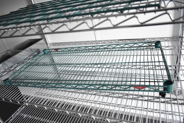 Metal wire shelving units inside the 2020 SDG 8.5' x 20' food trailer shell, ready for customization.