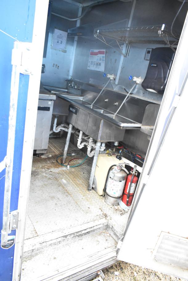 2019 Cruising Kitchens trailer interior with dual wash sinks, CaptiveAire grease hood, fire suppression, and Arctic Air appliances.