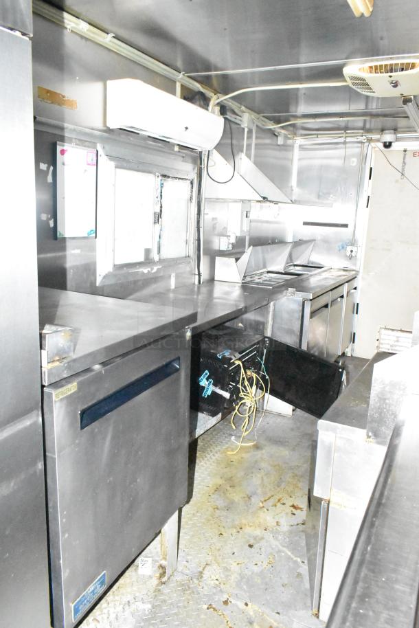 2019 Cruising Kitchens 8.5' x 24' trailer interior, featuring CaptiveAire grease hood, Arctic Air prep tables, and coolers.