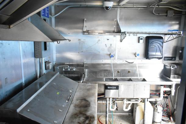 2019 Cruising Kitchens 8.5' x 24' food trailer interior with CaptiveAire grease hood, sinks, and fire suppression system. Clean condition.
