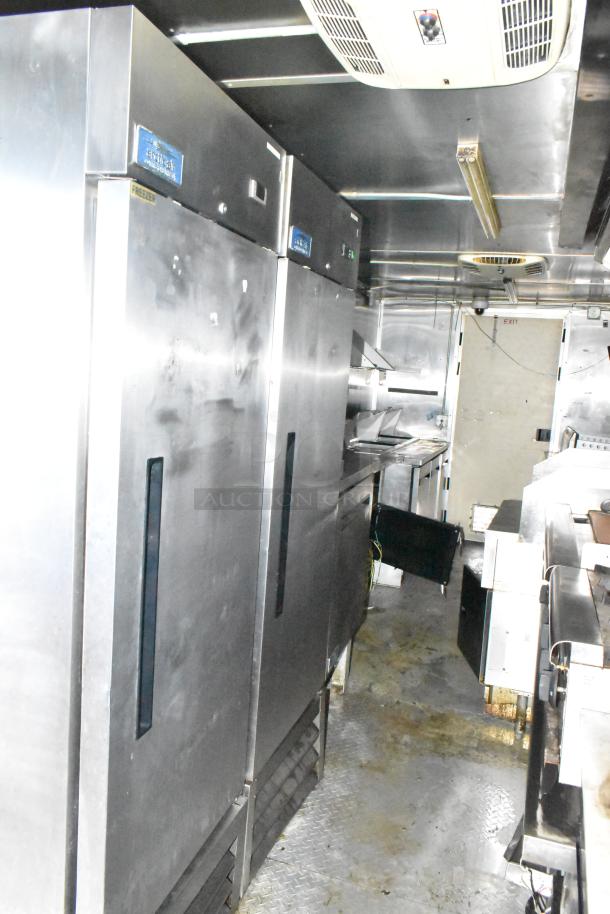 2019 Cruising Kitchens 8.5' x 24' trailer interior with Arctic Air coolers, prep tables, grease hood, fire system.