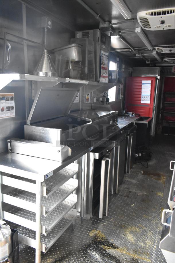 2021 Titanium Cargo 8.5' x 28' mobile kitchen trailer; equipped with a Henny Penny fryer, Taylor soft serve, Garland griddle.