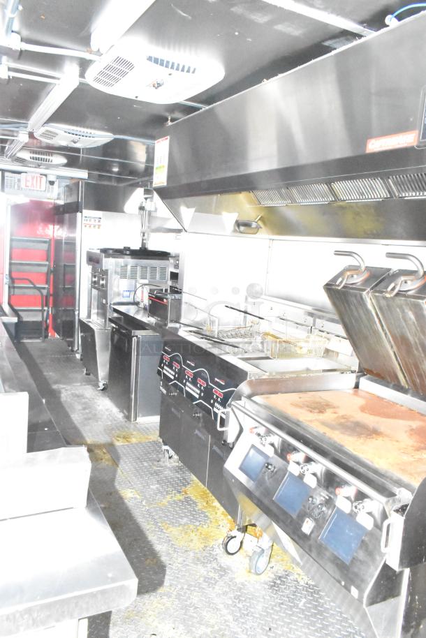 2021 Titanium Cargo 8.5' x 28' mobile kitchen trailer, features Henny Penny fryer, Taylor soft serve, Garland griddle, CaptiveAire hood.
