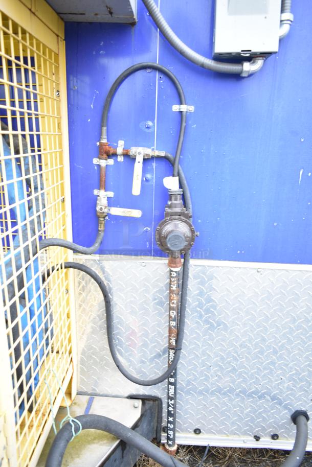 Exterior piping and connectors of a fully outfitted Burger King mobile kitchen trailer, featuring metal and rubber materials.