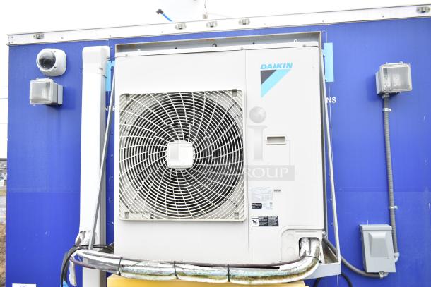 Exterior view of Burger King mobile kitchen trailer showing a Daikin HVAC unit mounted on a blue wall.