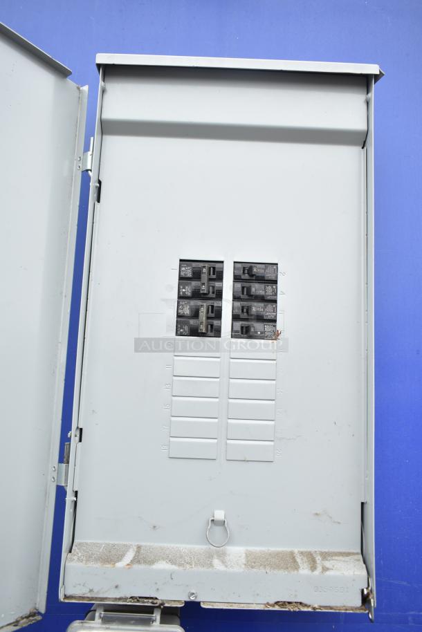 Electrical panel in mobile kitchen trailer, showing circuit breakers and capacity markings, indicating operational status.